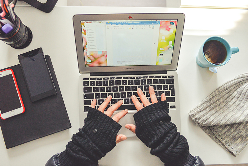 Person in black long sleeve shirt using macbook pro