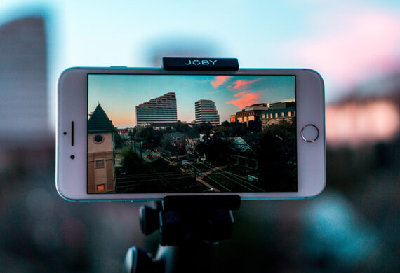 White smartphone making avideo of cities with buildings