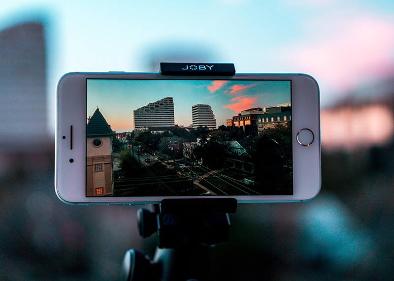 White smartphone making avideo of cities with buildings