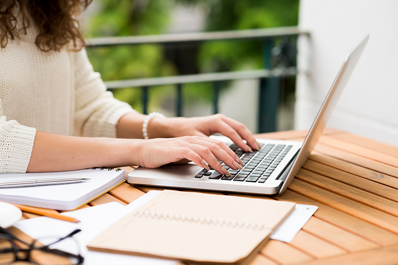 Side view of woman working on laptop