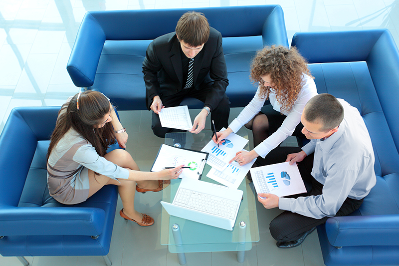 A group of four business people having a meeting