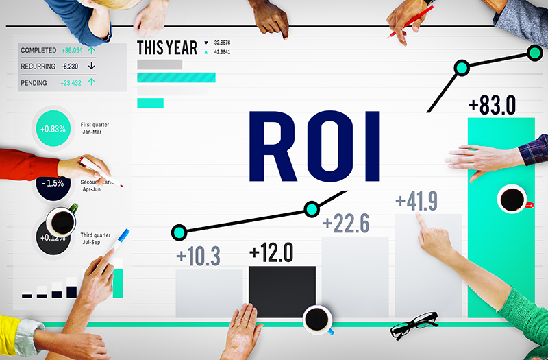 group of people having a meeting with word ROI on their table