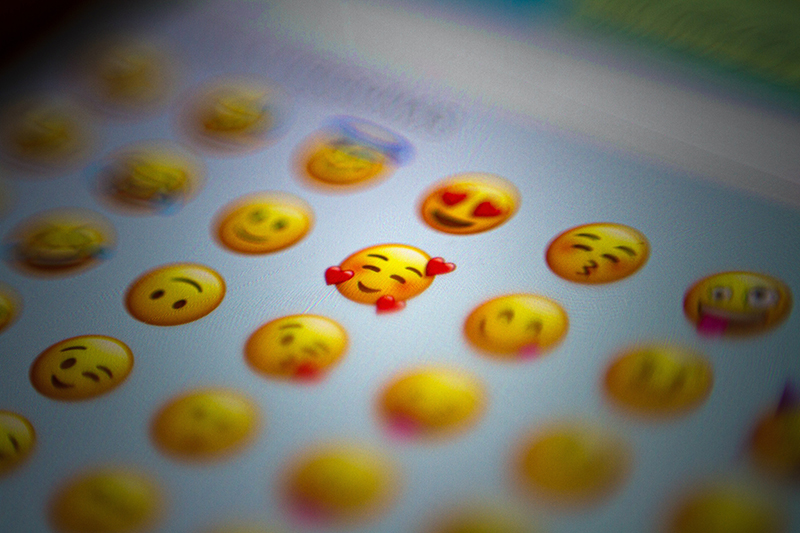 photo of smartphone screen with emoji/emoticons