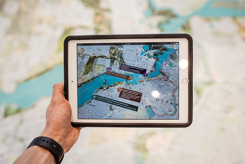 person holding a white iPad with black case 