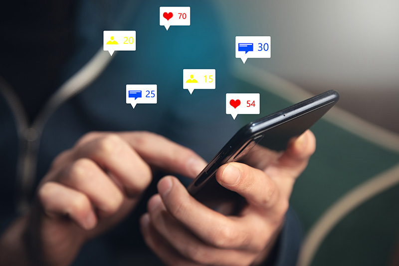 man holding social media icons with smart phone