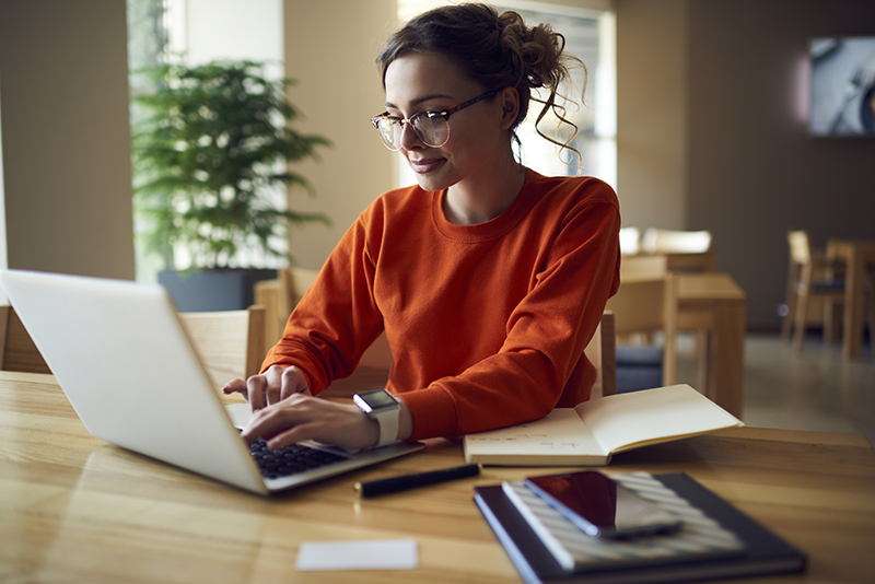 Professional young copywriter in trendy eyewear working on creation advertising 