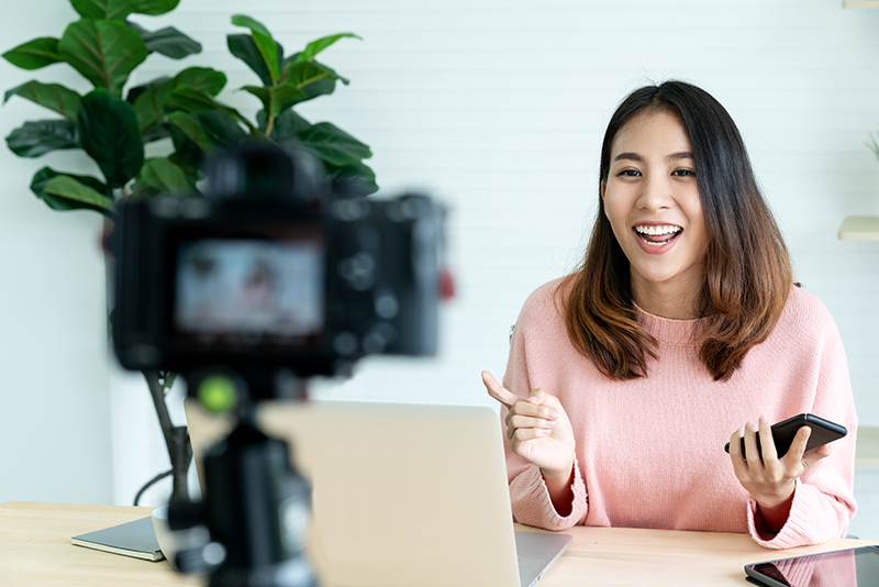 vlogger looking at camera and talking on video shooting with technology