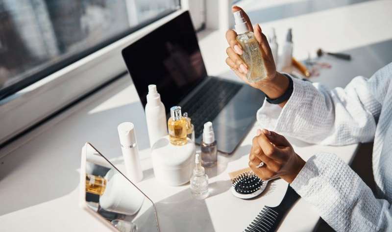 Female hands holding bottle of serum or essential oil