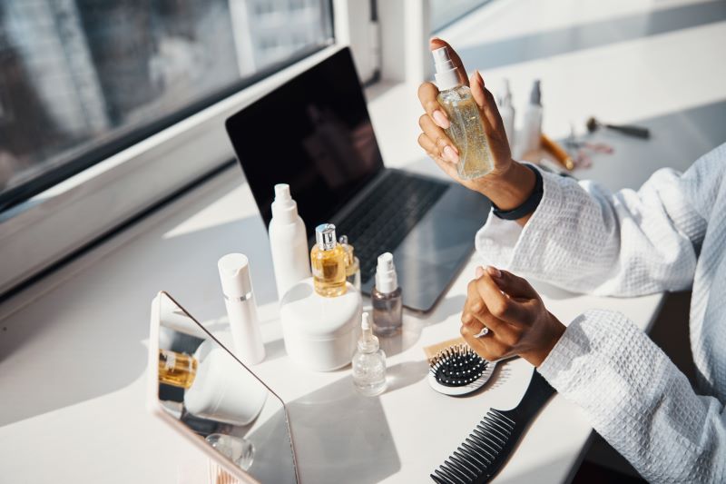 Female hands holding bottle of serum or essential oil