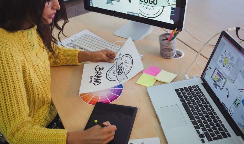Young graphic designer working at office desk